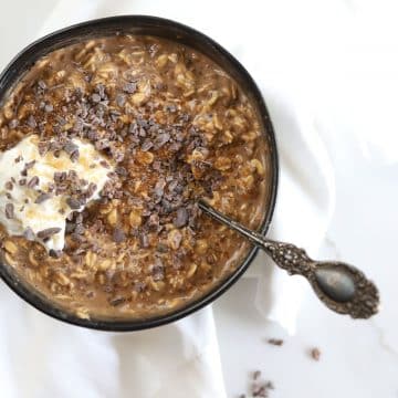 Tiramisu Overnight Oats topped with turbinado sugar, cacao nibs and a dollop of yogurt.
