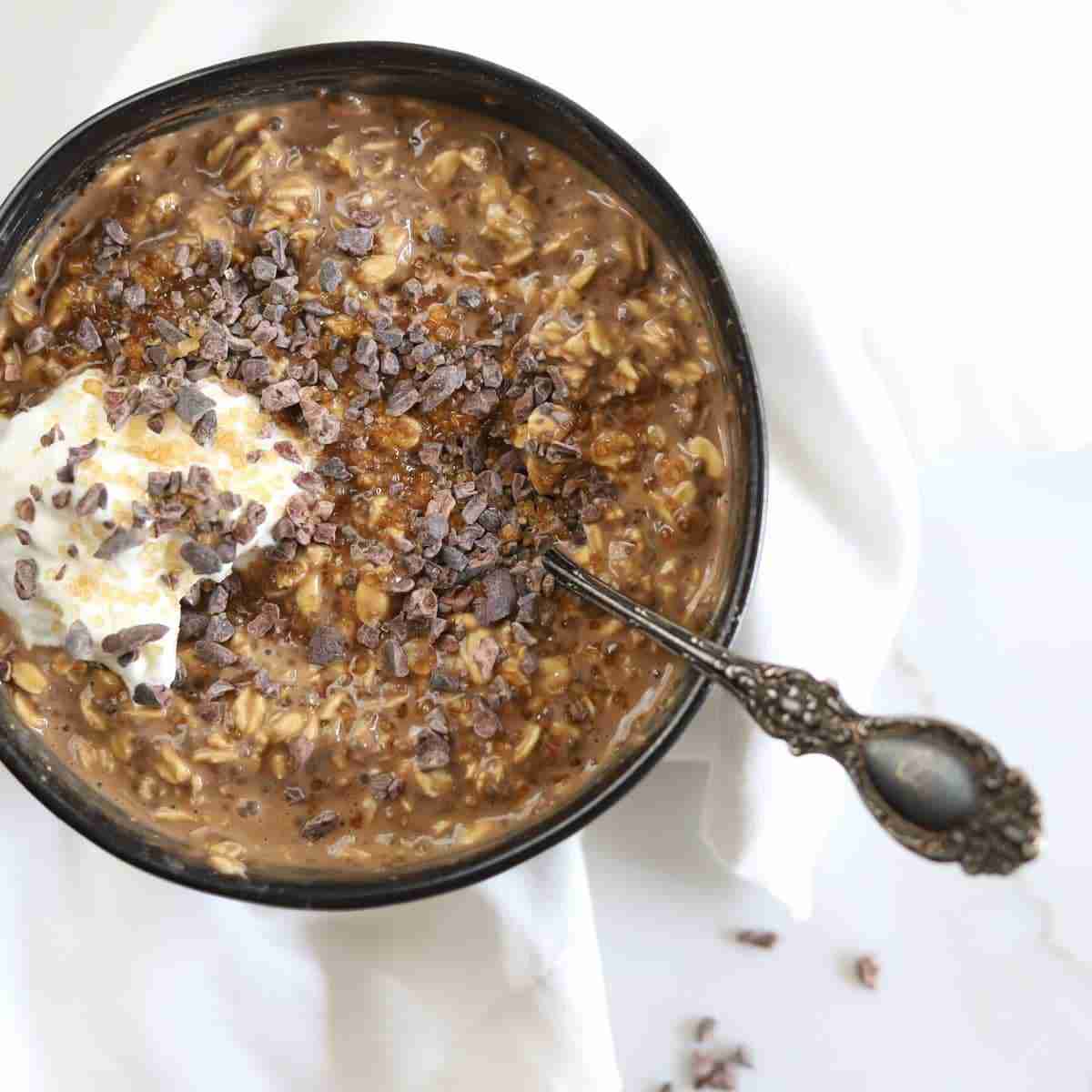 Tiramisu Overnight Oats topped with turbinado sugar, cacao nibs and a dollop of yogurt.
